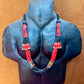 Necklace with colorful beads on a mannequin bust against a brown background