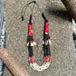 Colorful beaded necklace on a textured surface